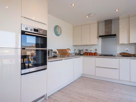 A kitchen with appliances and storage at Serfaus in Perranporth