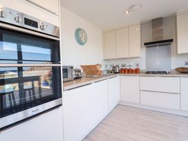 A kitchen with an oven, microwave, and stove at Serfaus in Perranporth
