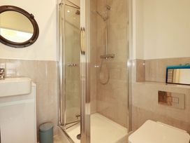 A bathroom with a shower, toilet and sink at Serfaus in Perranporth