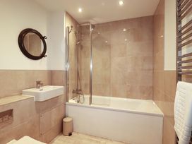 A bathroom with a bathtub and sink at Serfaus in Perranporth