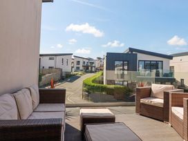 An outdoor seating area with a view of buildings at Serfaus in Perranporth