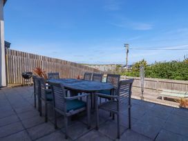 A patio with a table and chairs at Serfaus in Perranporth