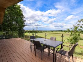 An outdoor area with a table and chairs at Freedom Lodge @ Summerfield Farm, Whitby