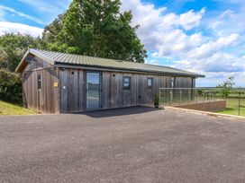 A wooden building with a deck at Freedom Lodge @ Summerfield Farm Whitby