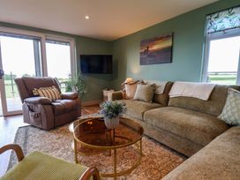 A living room with a sofa and coffee table at Freedom Lodge @ Summerfield Farm in Whitby