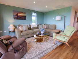 A living room with a sofa and coffee table at Freedom Lodge @ Summerfield Farm in Whitby