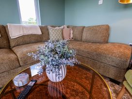 A living room with a sofa and coffee table at Freedom Lodge @ Summerfield Farm, Whitby