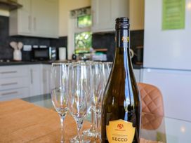 A kitchen with champagne flutes and a bottle of Secco at Freedom Lodge @ Summerfield Farm, Whitby
