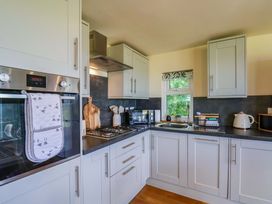 A kitchen with appliances and cabinets at Freedom Lodge @ Summerfield Farm in Whitby