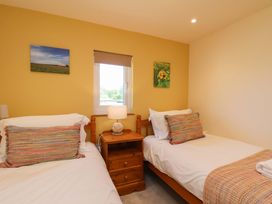 A bedroom with two beds and a window at Freedom Lodge @ Summerfield Farm, Whitby