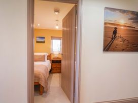 A bedroom with a bed and nightstand at Freedom Lodge @ Summerfield Farm, Whitby