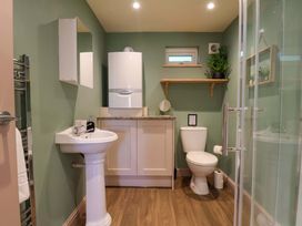 A bathroom with sink, toilet and shower enclosure at Freedom Lodge @ Summerfield Farm, Whitby