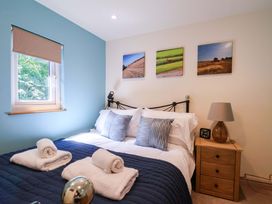 A bedroom with a bed and bedside table at Freedom Lodge @ Summerfield Farm in Whitby