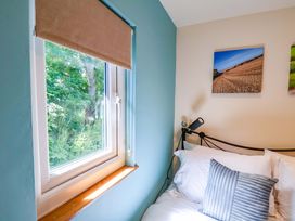 A bedroom with a window and bed at Freedom Lodge @ Summerfield Farm, Whitby