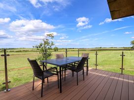 An outdoor dining area with a table and chairs at Freedom Lodge @ Summerfield Farm Whitby