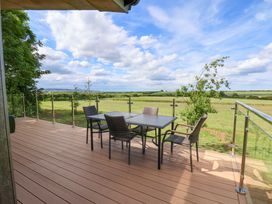 An outdoor seating area with table and chairs at Freedom Lodge @ Summerfield Farm Whitby