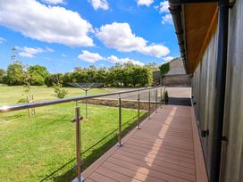An outdoor area with decking and railing at Freedom Lodge @ Summerfield Farm in Whitby