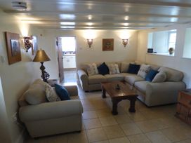 A living room with a sofa and coffee table at Trelake Cottage