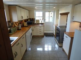 A kitchen with appliances and countertops at Trelake Cottage 