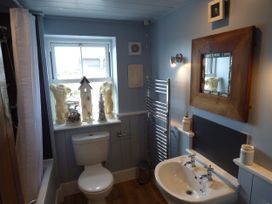 A bathroom with a toilet and sink at Trelake Cottage