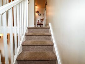 A staircase leading to a hallway at Trelake Cottage in Tintagel