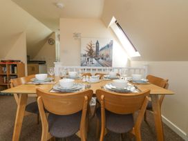 A dining room with a table set for a meal at Honeycombe Lodge