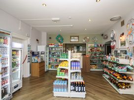 A shop displaying shelves of canned goods and snacks at Honeycombe Lodge