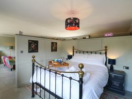 A bedroom with a bed and nightstand at The Annexe @ Shotley Cottage Shotley Gate