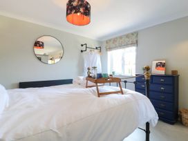 A bedroom with a bed and dresser at The Annexe @ Shotley Cottage, Shotley Gate