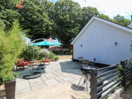 A garden with seating and a grill at The Annexe @ Shotley Cottage, Shotley Gate