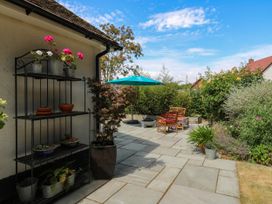 A garden with a shelving unit and seating area at The Annexe @ Shotley Cottage in Shotley Gate