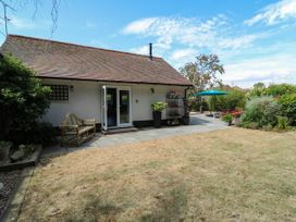 A garden with a house and patio at The Annexe @ Shotley Cottage in Shotley Gate