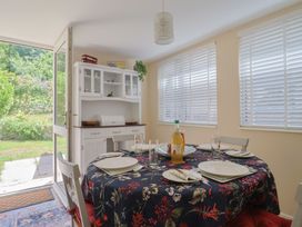 A dining room with a table set for meals at Tane in Winterborne Stickland
