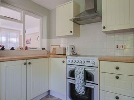 A kitchen with stove and kettle at Tane in Winterborne Stickland