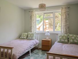 A bedroom with two beds and a window at Tane in Winterborne Stickland