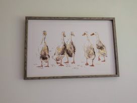A painting of ducks in a framed display