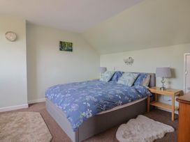 A bedroom with a bed and bedside lamps at Tane in Winterborne Stickland