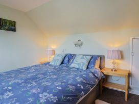 A bedroom with a bed and bedside tables at Tane in Winterborne Stickland