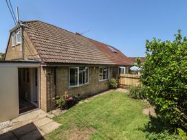 A house with a garden and fence at Tane in Winterborne Stickland