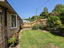 A garden with grass and plants at Tane in Winterborne Stickland