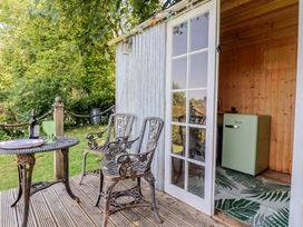 An outdoor seating area with a table and chairs at Tane in Winterborne Stickland