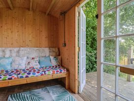 A snug with a sofa and cushions at Tane in Winterborne Stickland