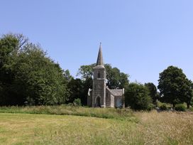 A church building surrounded by trees and grass at Tane in Winterborne Stickland