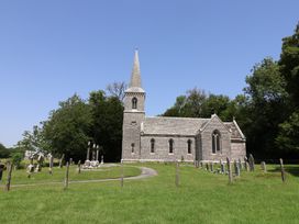 A church surrounded by graves and trees at Tane in Winterborne Stickland