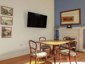 A dining room with a table and chairs at Farthings, The Old Chapel in St Austell