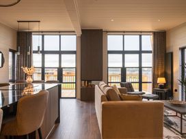 A living room with a sofa and dining area at Exclusive Tempest Spa in Grimsby