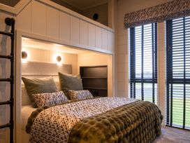 A bedroom with a bed and windows at Exclusive Tempest Spa in Grimsby