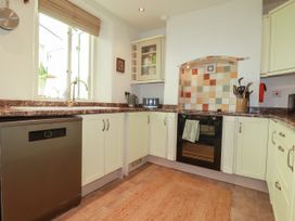 A kitchen with a sink and oven at 18 Tregea Terrace in Portreath
