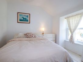 A bedroom featuring a bed and a dresser at 18 Tregea Terrace in Portreath