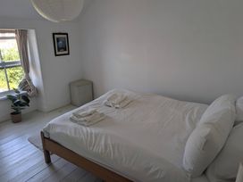 A bedroom with a bed and a window at Fairsands Portreath